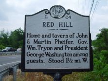 Large metallic marker that reads: "RED HILL, Home and tavern of John & Martin Pheifer. Gov. Wm. Tryon and President George Washington among guests. Stood 1 1/2 mi. W."